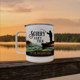 White travel mug with fisherman reading Sorry, I can't Talk, I'm on another line personalized with a name