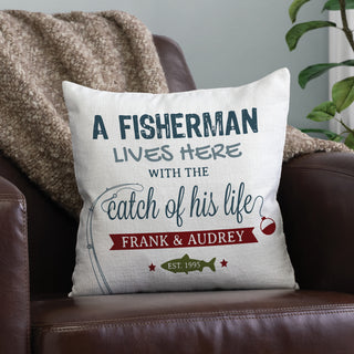 A 14" pillow with fishing graphic reading A fisherman lives here with the catch of his life personalized with your message